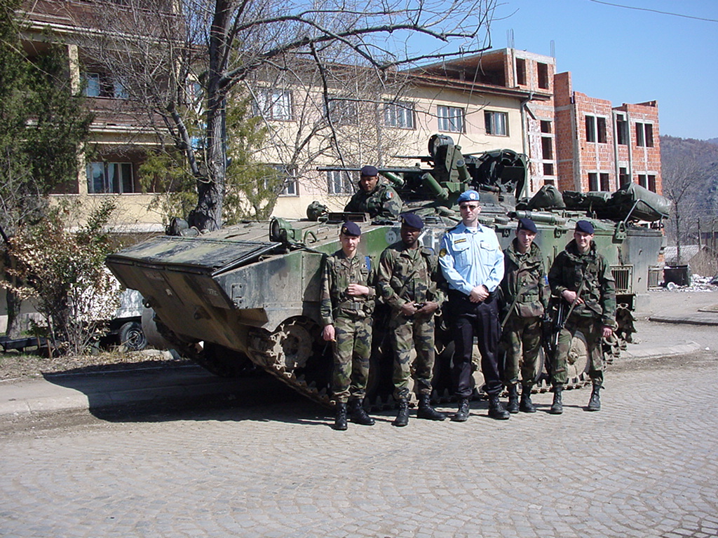 A group of men standing next to a tank
Description automatically generated with medium confidence